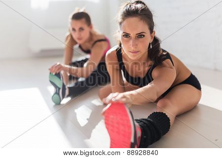 Group of fit women working stretching leg muscles back to warm up at gym fitness, sport, training an