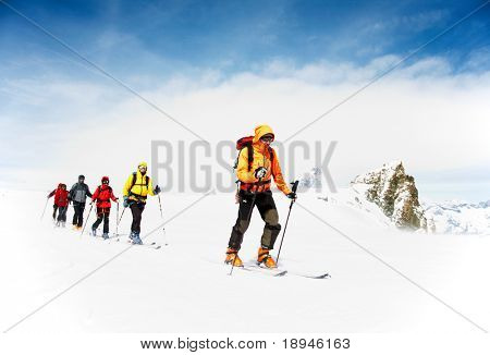 Group of alpine touring skiers on the big Verra Glacier; in background the Matterhorn, Swiss-Italy border.