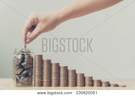 Hand Putting Coins In Jar With Money Stack Step Growing Growth, Saving Money Or Investment Financial