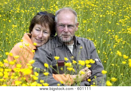 Senior Couple In A Buttercup Field