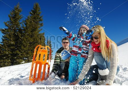 Winter season. Happy family having fun on fresh snow on vacation.