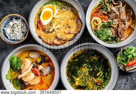 Assorted Traditional Asian Soups. Miso, Ramen, Tom Yam, Pho Bo. Black Background. Top View