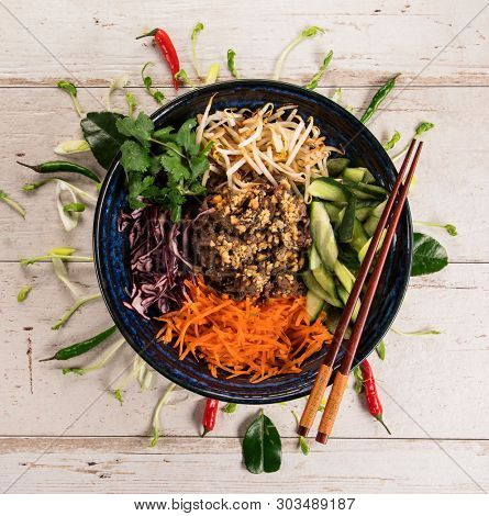 Bun bo nam bo asian food background with various ingredients on rustic wooden background , top view. Vietnam or Thai cuisine.