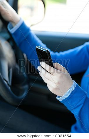 Close-up Of A Caucasian Young Woman Sending A Text While Driving