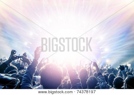 Outdoor concert, happy people with raised up hand enjoying night in the club, night entertainment, active lifestyle, New Year celebration, partying concept