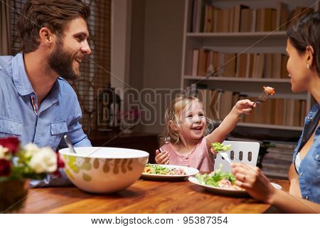 Family eating an dinner at a dining table