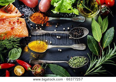 Delicious  portion of fresh salmon fillet  with aromatic herbs, spices and vegetables - healthy food, diet or cooking concept