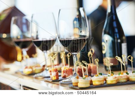 catering services background with snacks and glasses of wine on bartender counter in restaurant