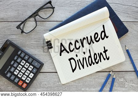 Accrued Dividend, Text On A Notepad Page. Two Notebooks On The Table