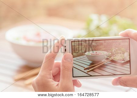 Taking A Picture Of Beef Noodle Soup In Street Cafe In Vietnam