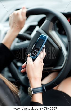 Close-up Of A Businesswoman Sending A Text While Driving