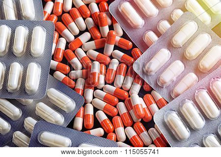 Heap of red orange white round pills