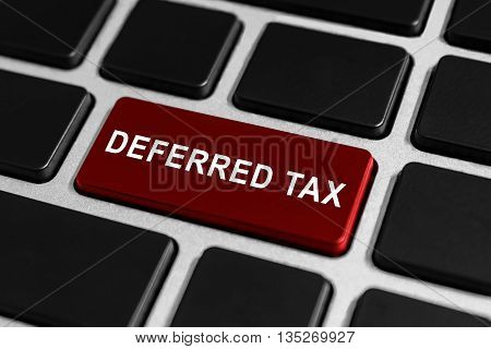 deferred tax red button on keyboard business concept