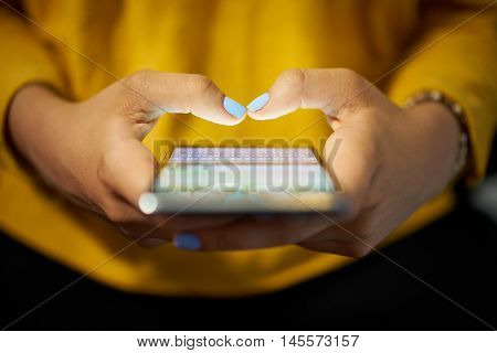 Woman Typing Phone Message On Social Network At Night