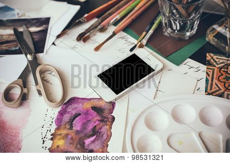 Smartphone on a table in the artist studio