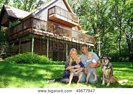 Happy Family At Cabin In The Woods