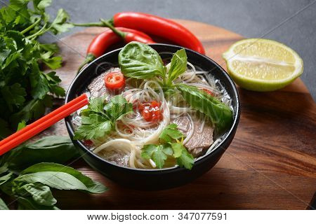 Traditional Vietnamese Soup Pho Bo With Herbs,beef, Rice Noodles,chili And Bean Sprouts . Vietnamese