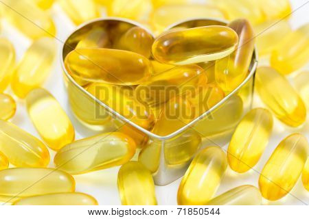 Fish Oil Pills On Heart Shape Box Isolated