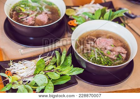 Pho Bo - Vietnamese Fresh Rice Noodle Soup With Beef, Herbs And Chili. Vietnam's National Dish