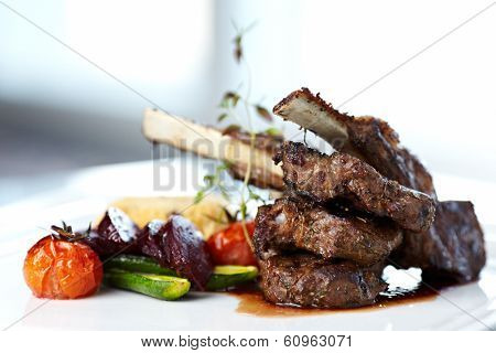 Grilled lamb carre with warm couscous salad, roasted vegetables, Dijon mustard and red wine sauce