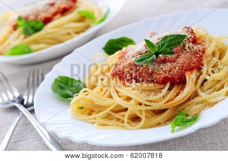 Pasta with tomato sauce basil and grated parmesan