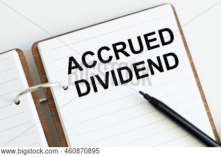 Business Concept. Accrued Dividend Text On Notepad Sheet On Table