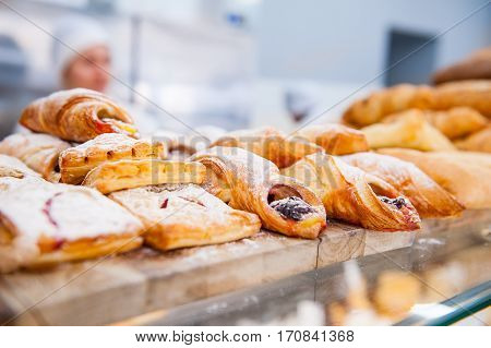 Close Up Freshly Baked Pastry Goods On Display In Bakery Shop. Selective Focus