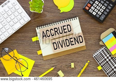 Accrued Dividend . Wooden Blocks On A Notepad With Text