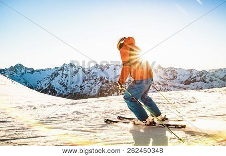 Professional Skier Athlete Skiing At Sunset On Top Of French Alps Ski Resort - Winter Vacation And S