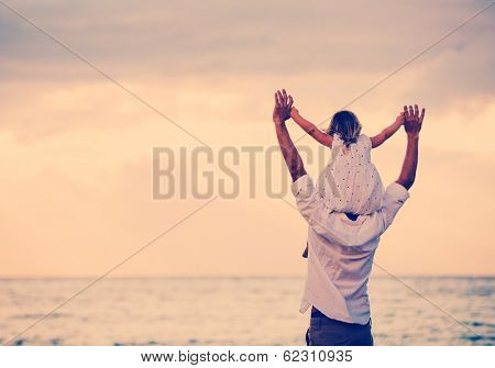 Father and Daughter Playing Together at the Beach at Sunset. Happy Fun Smiling Lifestyle