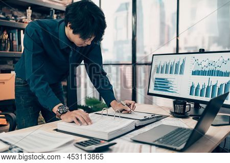 Investors Working On Desk Office And Using A Pan And Pointing To Check Tracking Cost, Balance, Proji