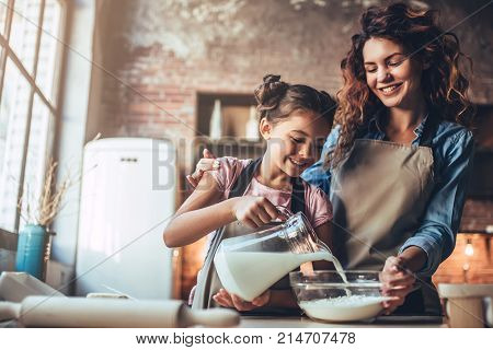 Mom With Daughter On Kitchen.