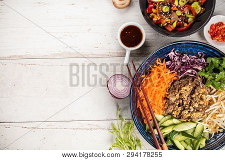 Top view composition of beef Bun bo nam bo, vietnamese food in bowl, free space for text