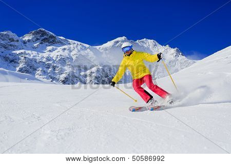 Skiing, skier, winter sport - woman skiing downhill