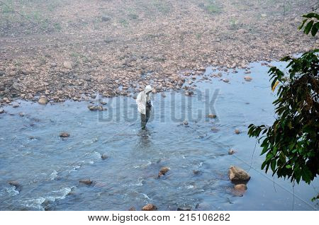 Traveler Thai Man Travel And Walking Crossing Small Stream In Morning Time At Ban Bo Kluea Village