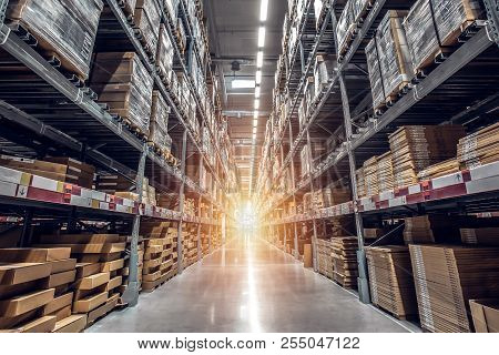 Warehouse Interior With Shelves, Pallets And Boxes, Rows Of Shelves With Goods Boxes In Modern Indus