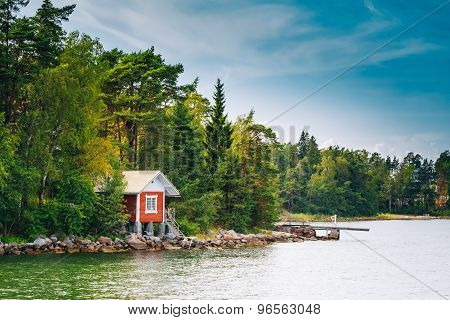 Red Finnish Wooden Bath Sauna Log Cabin On Island In Summer