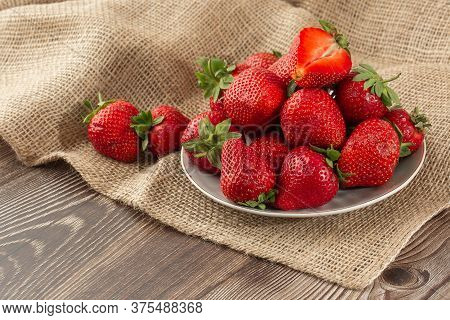 Fresh Strawberries In A Plate On Wooden Table. Fresh Nice Strawberries. Strawberry Field On Fruit Fa