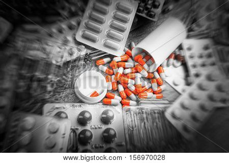 Pharmacy theme, Pharmaceutical medicament for health Drug ampules prescription for treatment medication. Heap of red orange white round capsule in stick pills with medicine antibiotic in packages