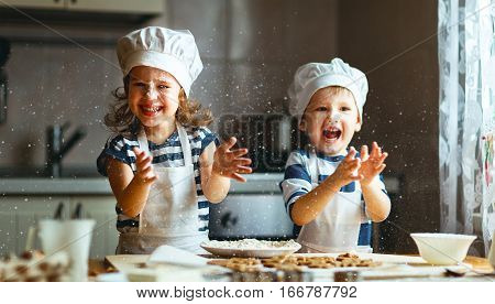 happy family funny kids are preparing the dough bake cookies in the kitchen