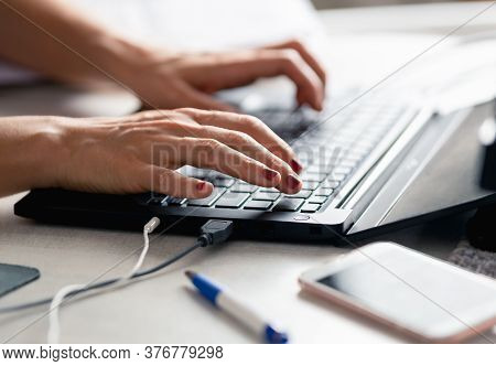 Woman working on laptop from home. Busy people lifestyle. Woman typing on laptop computer. Work from home lifestyle. Urban lifestyle. Woman typing message on laptop computer. Technology lifestyle. Typing message on computer. Laptop computer. Working at ho