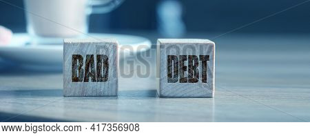 Bad Debts Phrase On Wooden Cubes And Cup Of Cacao. Business, Financial Concept