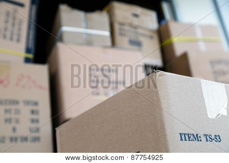 Pile Of Brown Cardboard Boxes At Warehouse Of Market