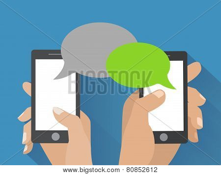 Hand holding smartphone with blank speech bubbles