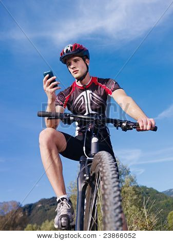 Young Man With Telephone Riding Mountain Bike