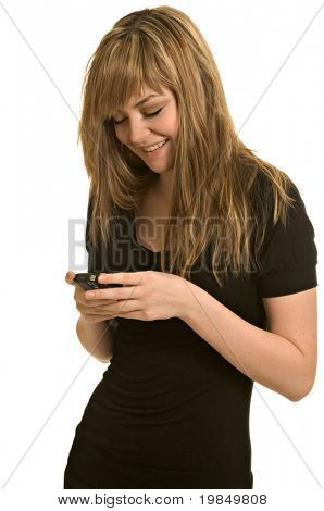 A pretty young woman reads a text message on her cell phone (isolated on white background)