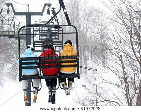 Skiers on chairlift at ski resort