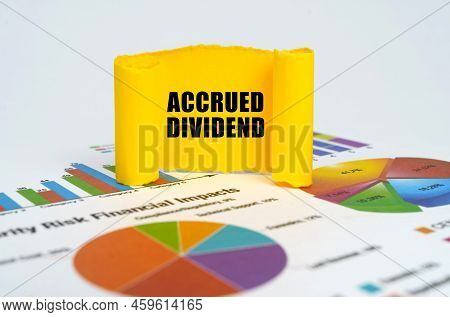 Business Concept. Against The Background Of Graphs And Charts, A Yellow Paper Plate With The Inscrip