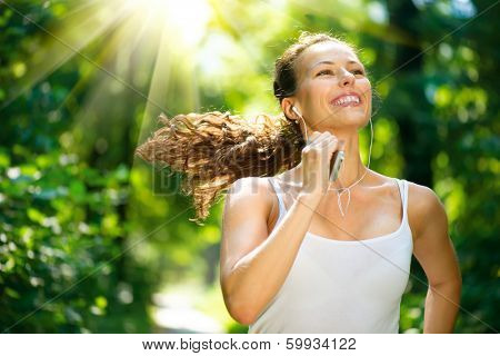 Running woman. Female Runner Jogging during Outdoor Workout in a Park. Beautiful fit Girl. Fitness model outdoors. Weight Loss. Healthy lifestyle. Morning